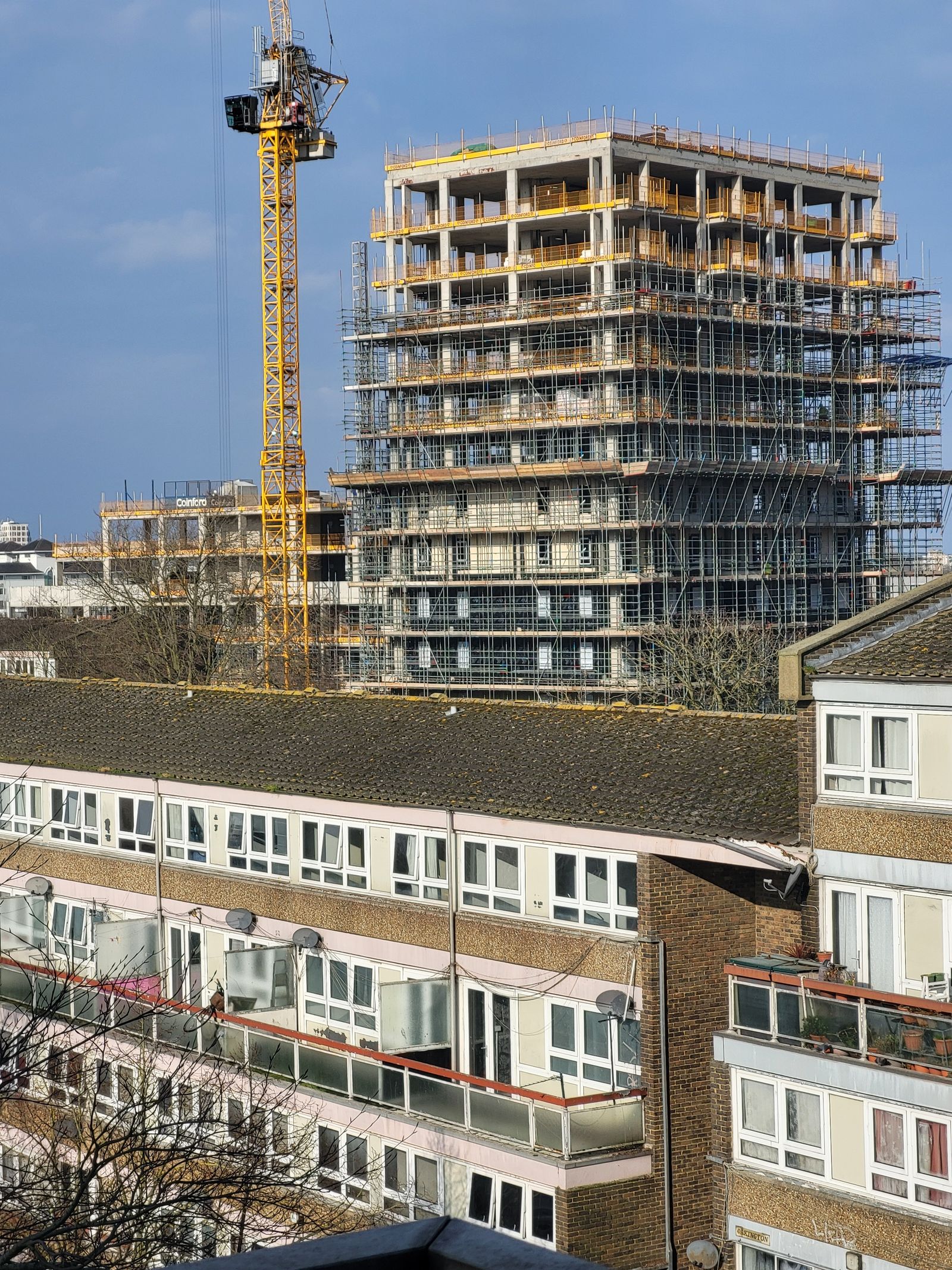 Steel-frame structure under construction against a clear sky
